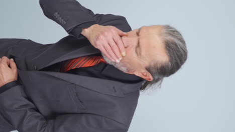 Vertical-video-of-Coughing-old-businessman.